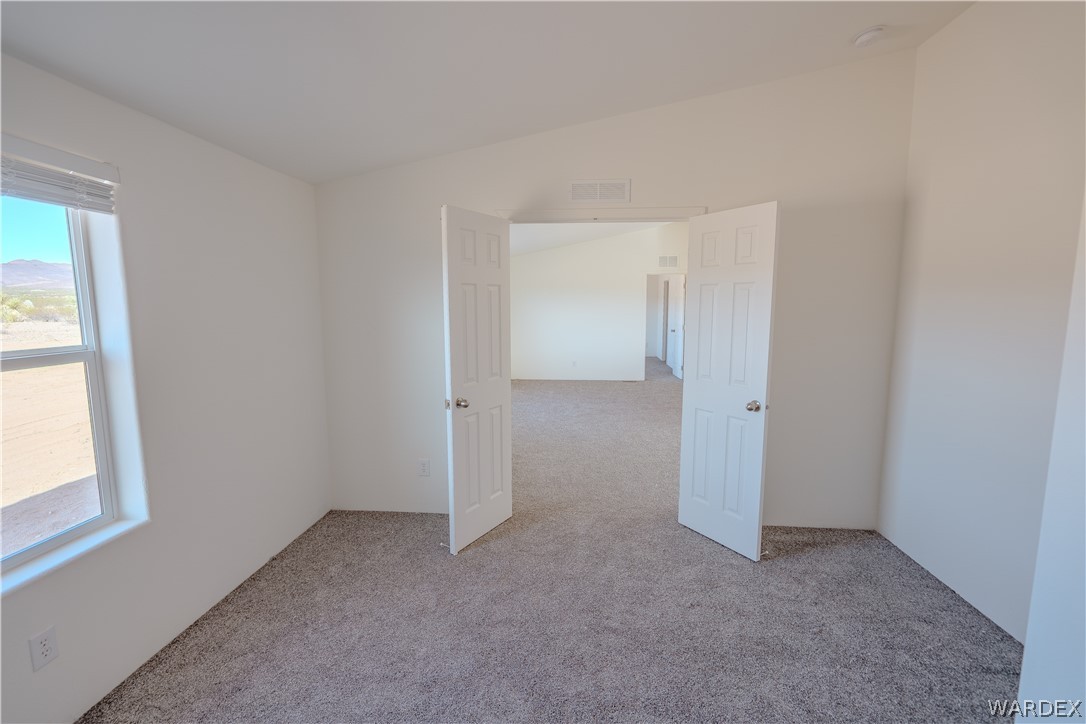 5746 Eden Road Golden Valley, AZ 86413 - Photo 20 of 27 an empty room with windows and closet