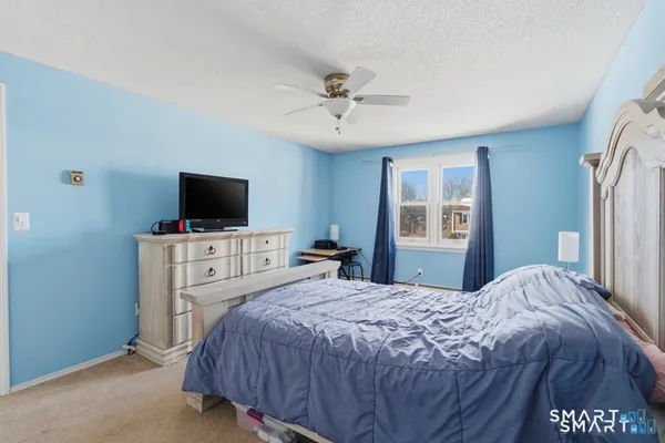 a bedroom with a bed and a chair