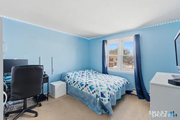 a bedroom with a bed and a desk