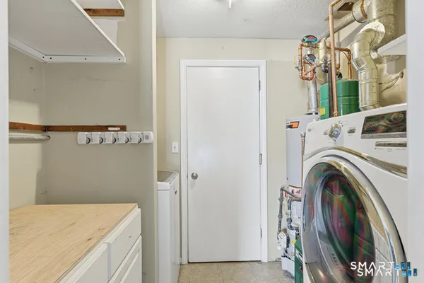 a view of a patio with table and chairs under an umbrella