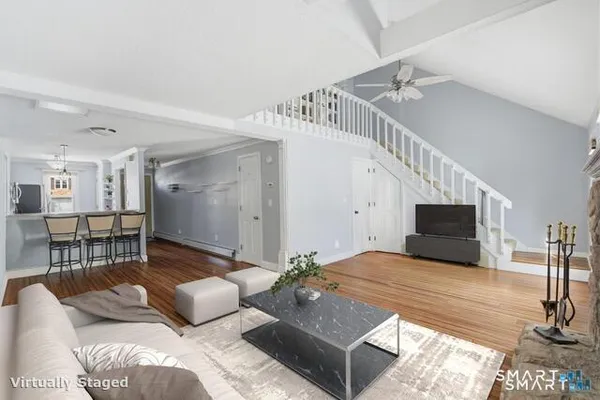 a living room with furniture and a flat screen tv