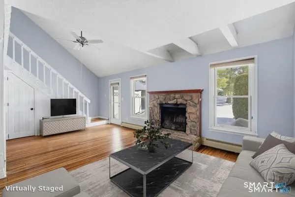 a living room with furniture and a fireplace