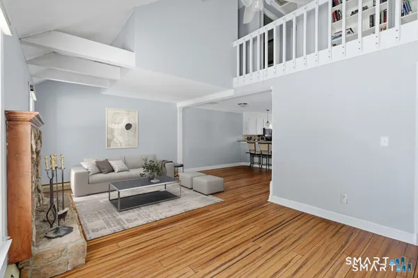 a bedroom with furniture and a wooden floor