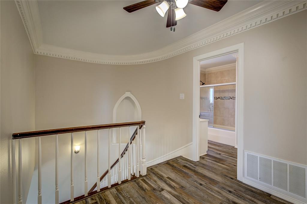 7359 Highway 154 Sulphur Springs, TX 75482 - Photo 23 of 40 Upstairs hallway landing, with hall bath visible. Note the curved wall and dentil molding