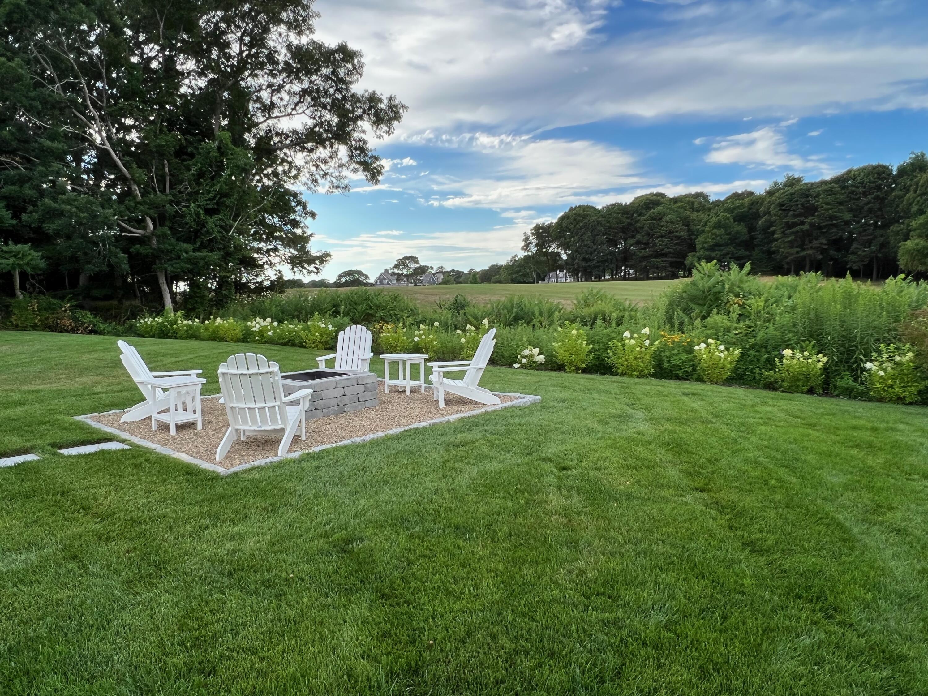 38 Crosby Circle Osterville, MA 02655 - Photo 22 of 28 a view of a table and chairs in the garden