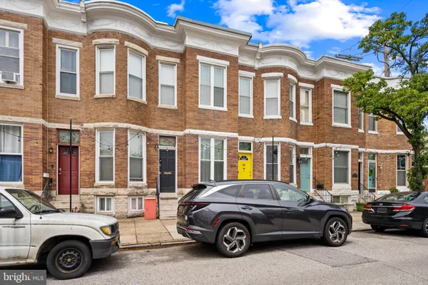 a car parked in front of a residential apartment building