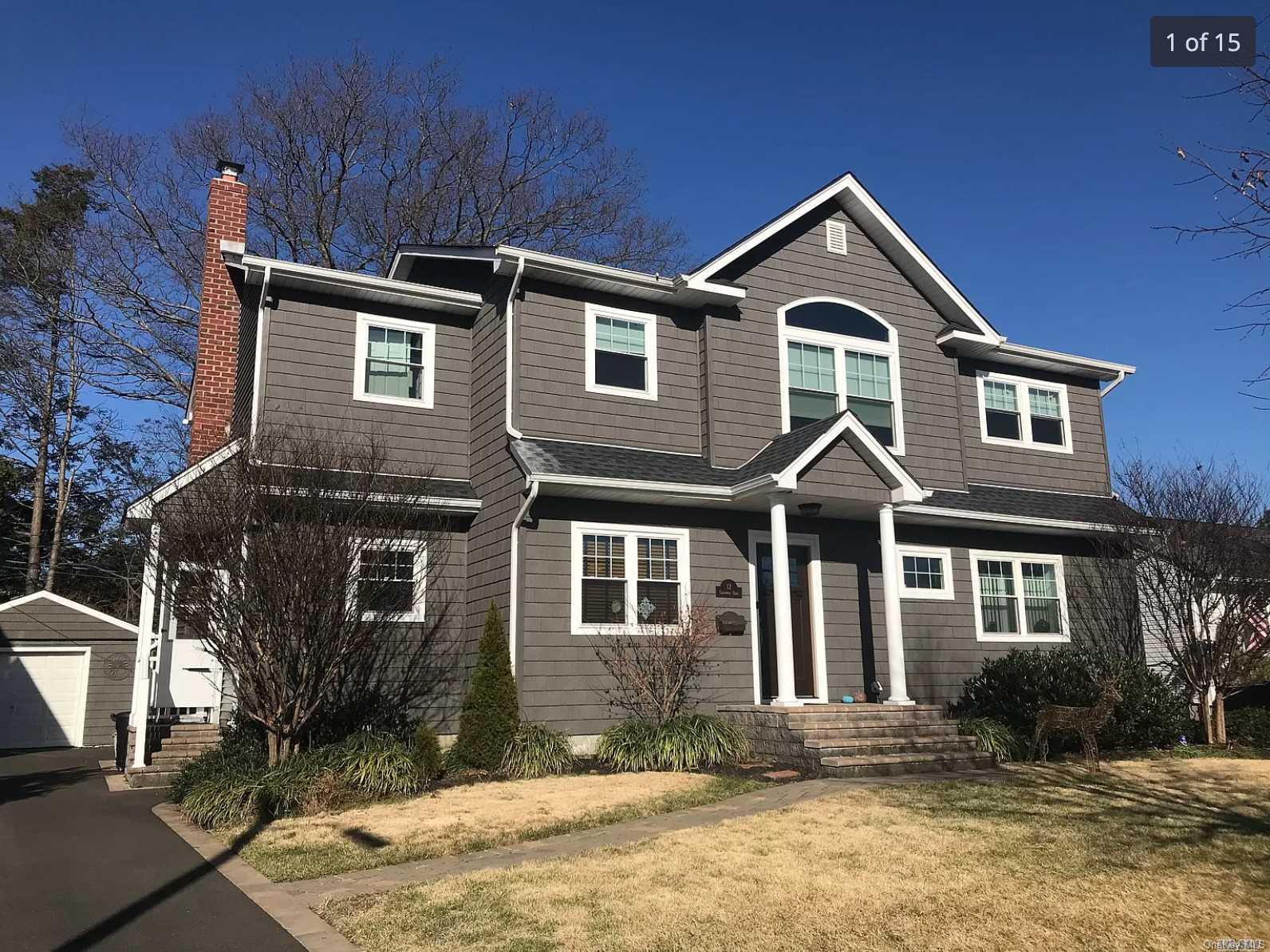 12 Chadwick Road Syosset, NY 11791 - Photo 1 of 1 a front view of a house with a yard