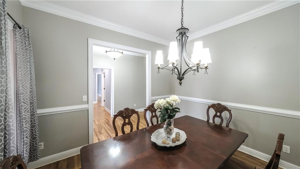 896 Winn Road Douglasville, GA 30134 - Photo 16 of 64 a view of a dining room with furniture a chandelier and wooden floor