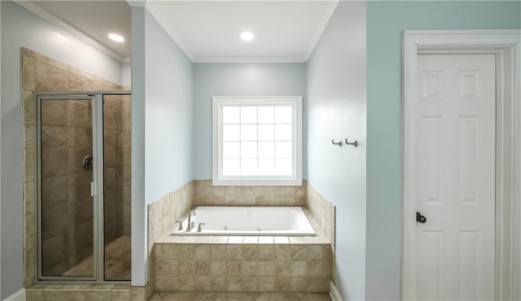 896 Winn Road Douglasville, GA 30134 - Photo 26 of 64 a bathroom with a bathtub and a shower