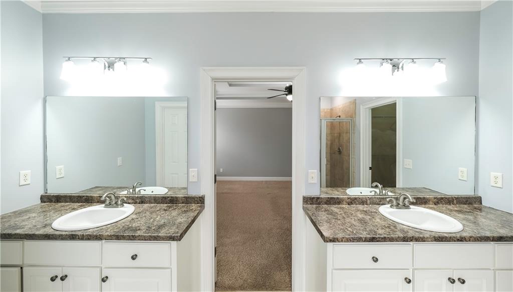 896 Winn Road Douglasville, GA 30134 - Photo 29 of 64 a bathroom with a granite countertop double vanity sinks and a mirror