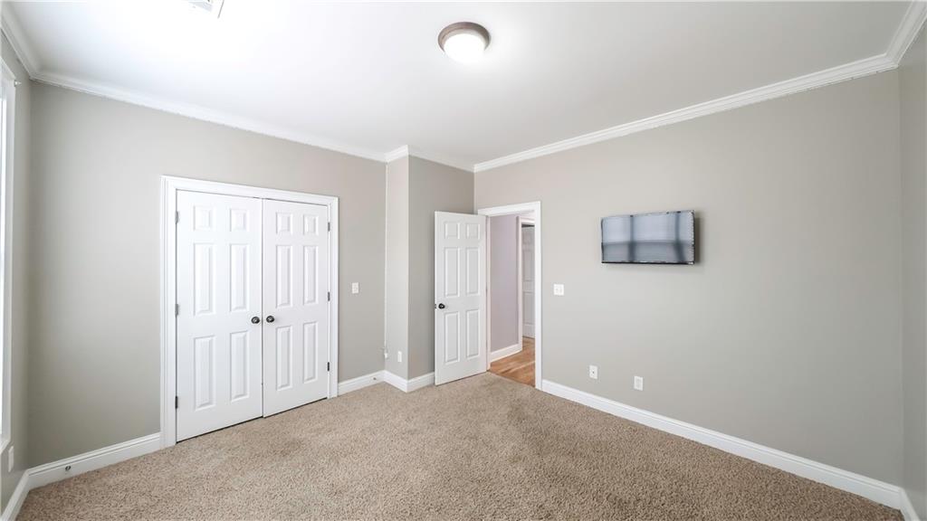 896 Winn Road Douglasville, GA 30134 - Photo 30 of 64 an empty room with closet and windows