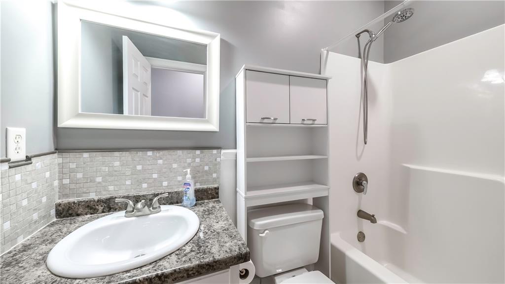 896 Winn Road Douglasville, GA 30134 - Photo 36 of 64 a bathroom with a granite countertop sink toilet and shower