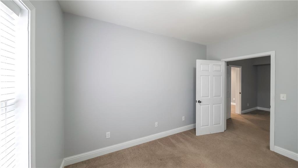 896 Winn Road Douglasville, GA 30134 - Photo 39 of 64 an empty room with windows