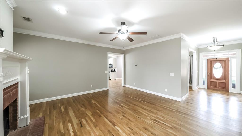 896 Winn Road Douglasville, GA 30134 - Photo 4 of 64 a view of an empty room with window and wooden floor