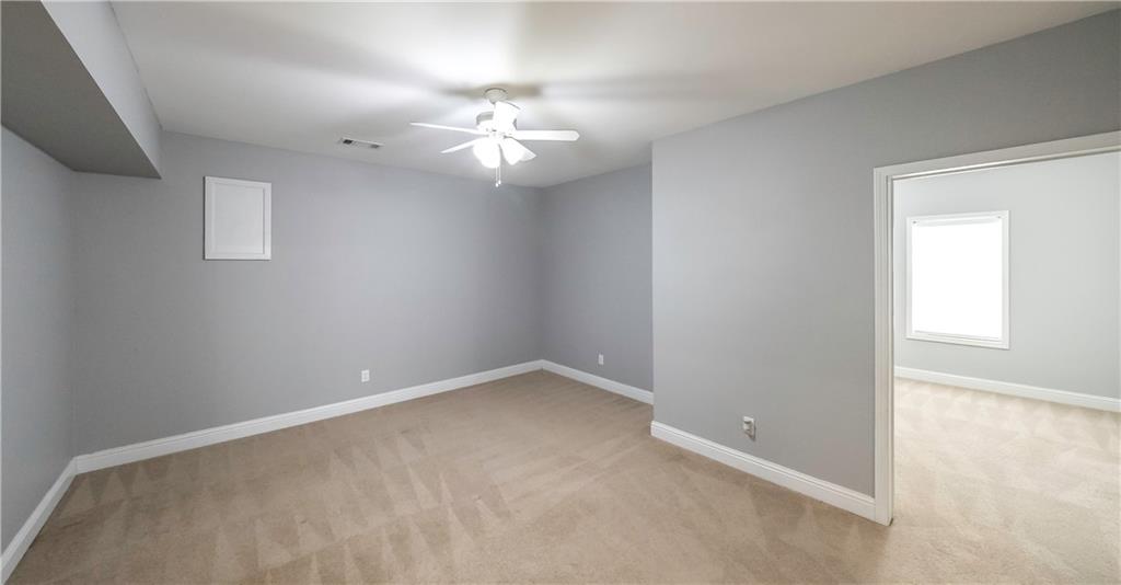 896 Winn Road Douglasville, GA 30134 - Photo 41 of 64 an empty room with a chandelier fan