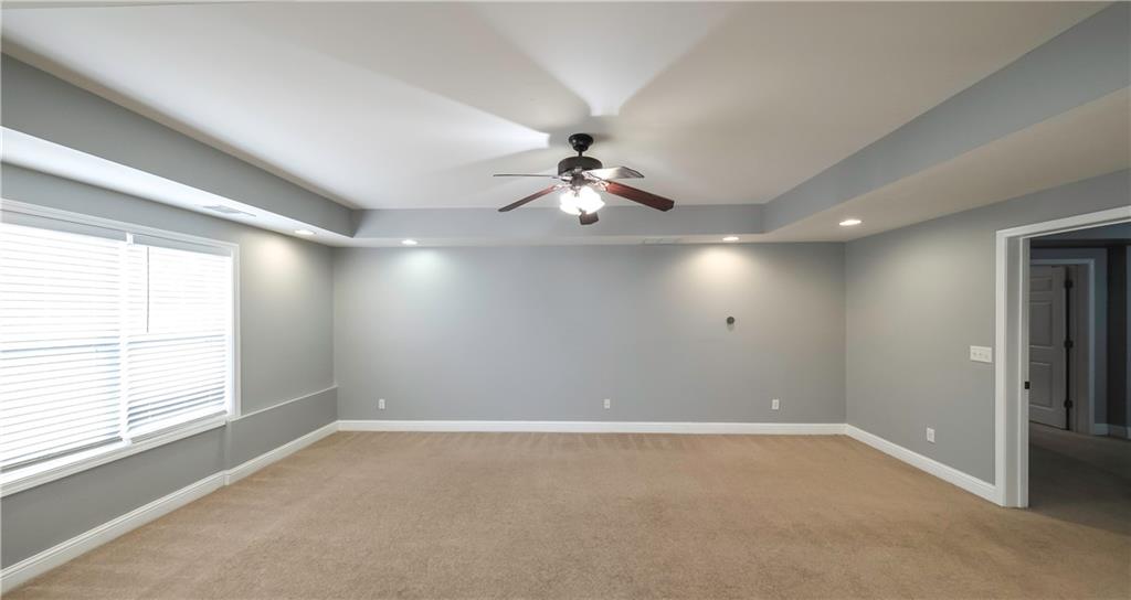 896 Winn Road Douglasville, GA 30134 - Photo 45 of 64 en empty room with windows and ceiling fan