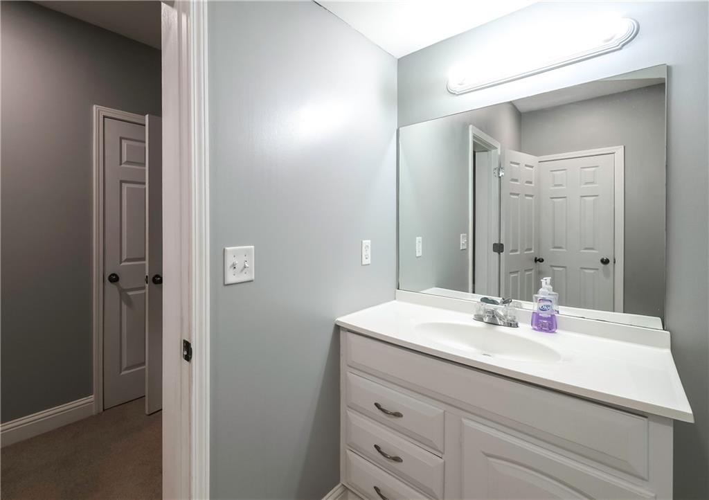 896 Winn Road Douglasville, GA 30134 - Photo 49 of 64 a bathroom with a sink and a mirror