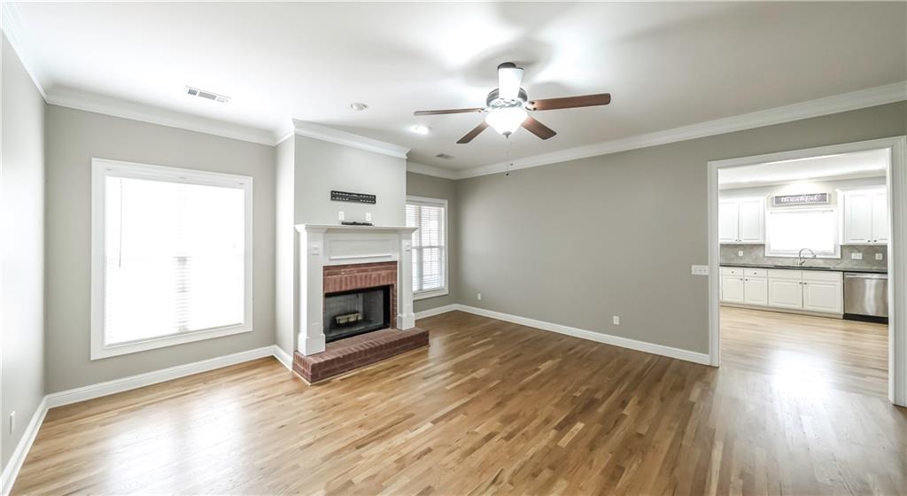 896 Winn Road Douglasville, GA 30134 - Photo 6 of 64 an empty room with wooden floor fireplace and windows