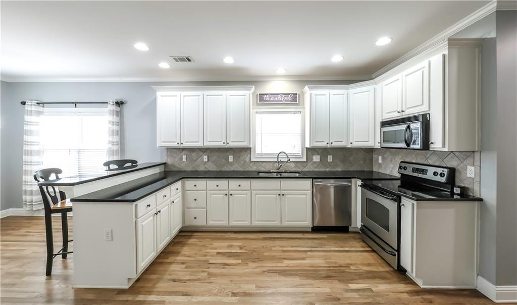 896 Winn Road Douglasville, GA 30134 - Photo 8 of 64 a kitchen with stainless steel appliances granite countertop a stove and a sink