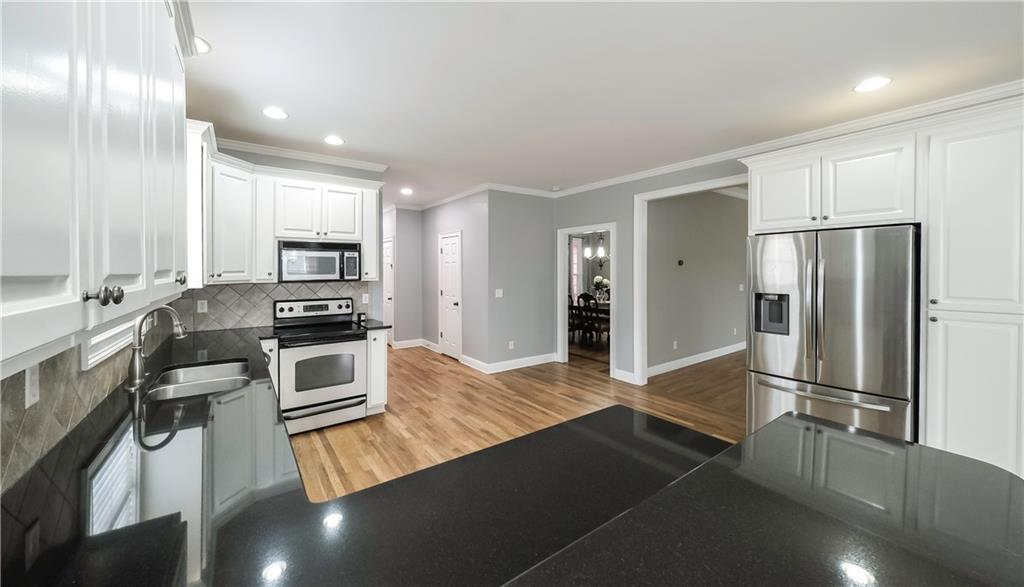 896 Winn Road Douglasville, GA 30134 - Photo 10 of 64 a kitchen with stainless steel appliances a refrigerator and stove