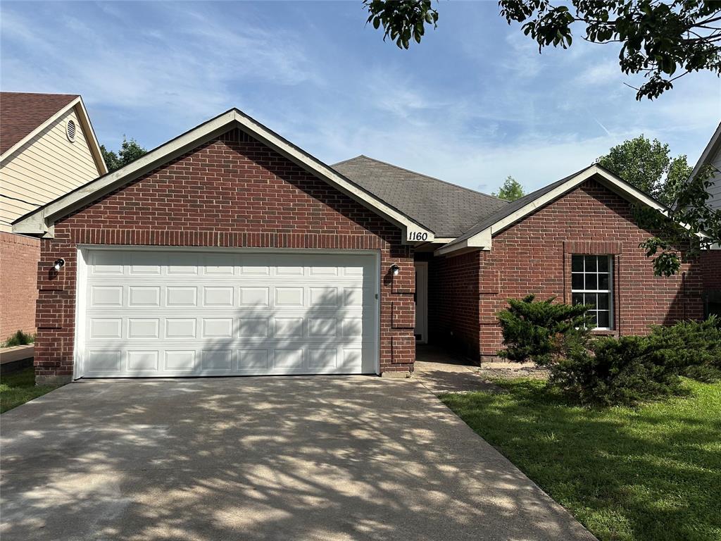 1160 South Beltline Road Dallas, TX 75253 - Photo 2 of 18 a front view of a house with a yard and garage