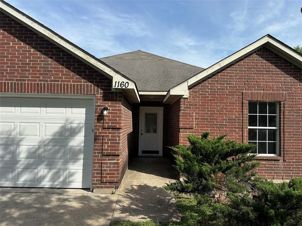 1160 South Beltline Road Dallas, TX 75253 - Photo 3 of 18 a front view of a house with a garage