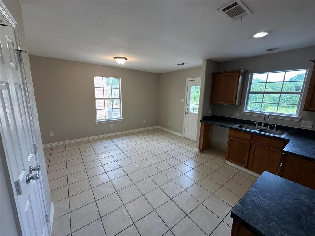 1160 South Beltline Road Dallas, TX 75253 - Photo 10 of 18 a view of an empty room with window and cabinet