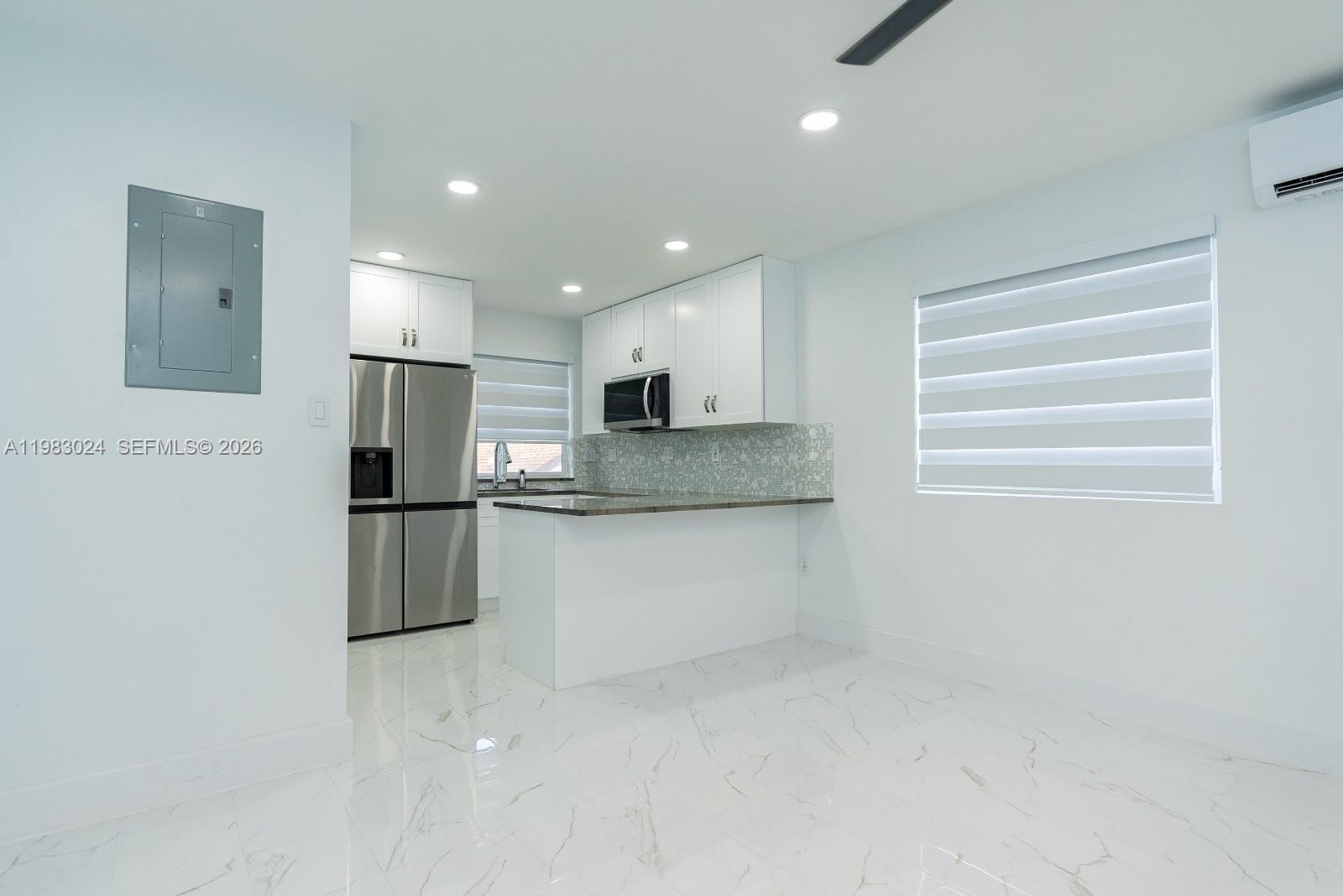 a kitchen with stainless steel appliances a refrigerator sink and microwave