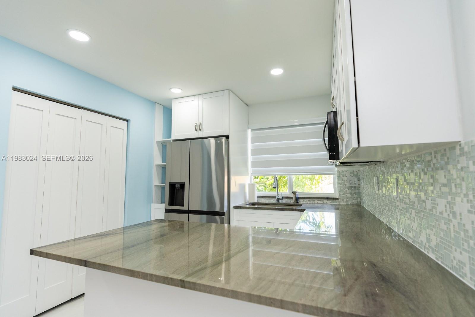 13270 Southwest 103rd Terrace, Unit 2 Miami, FL 33186 - Photo 19 of 41 a kitchen with stainless steel appliances granite countertop a refrigerator and a sink