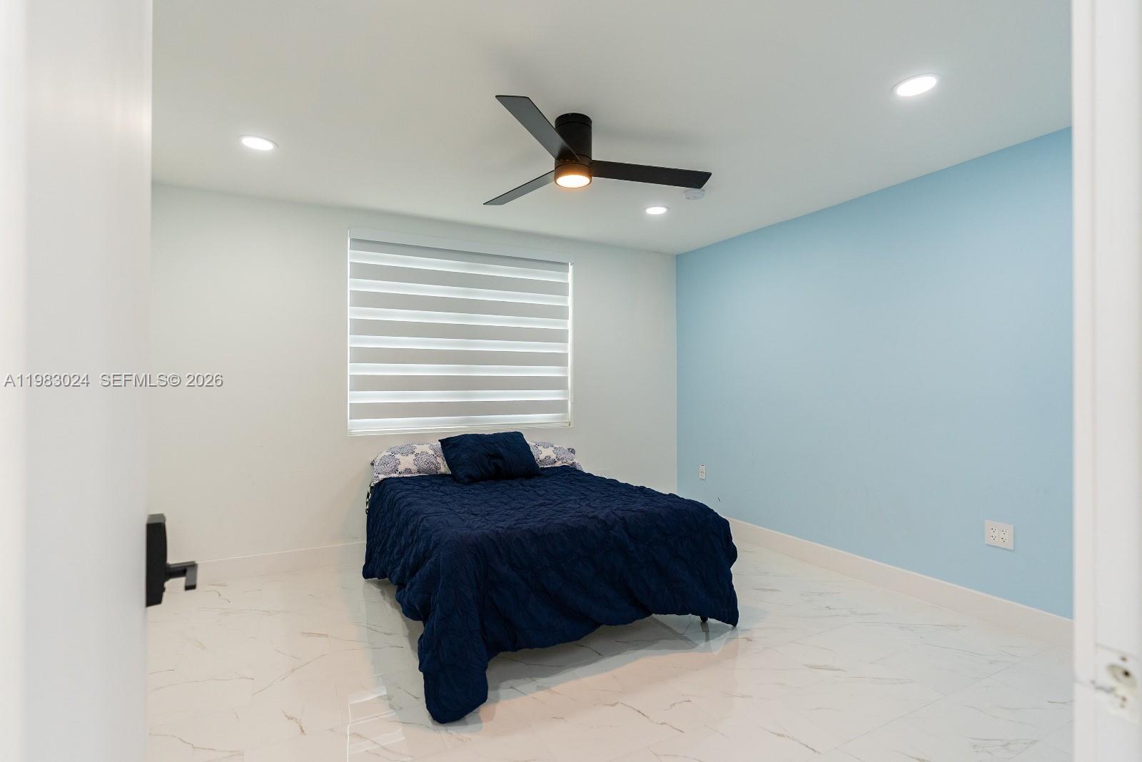 13270 Southwest 103rd Terrace, Unit 2 Miami, FL 33186 - Photo 25 of 41 a bedroom with a bed and a ceiling fan