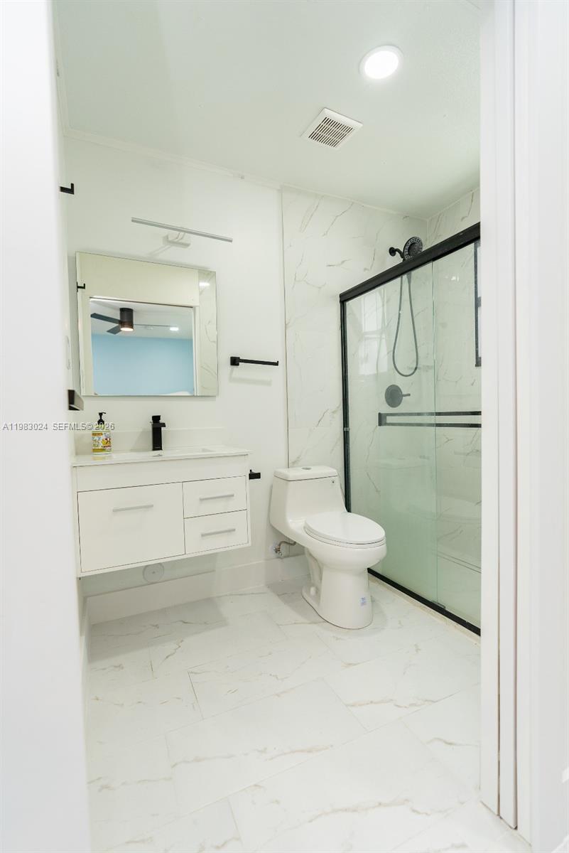 13270 Southwest 103rd Terrace, Unit 2 Miami, FL 33186 - Photo 26 of 41 a bathroom with a toilet sink and shower