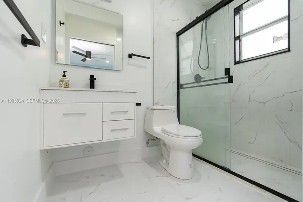 a bathroom with a sink toilet and mirror