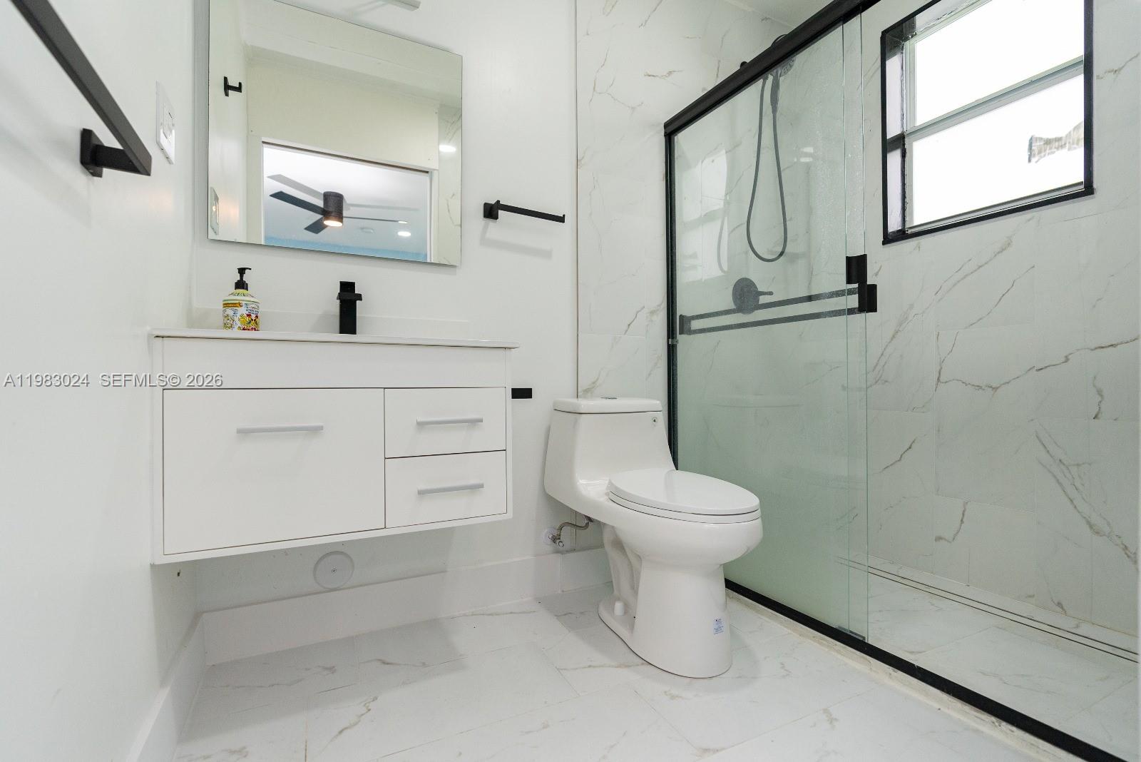 13270 Southwest 103rd Terrace, Unit 2 Miami, FL 33186 - Photo 28 of 41 a bathroom with a toilet sink and shower