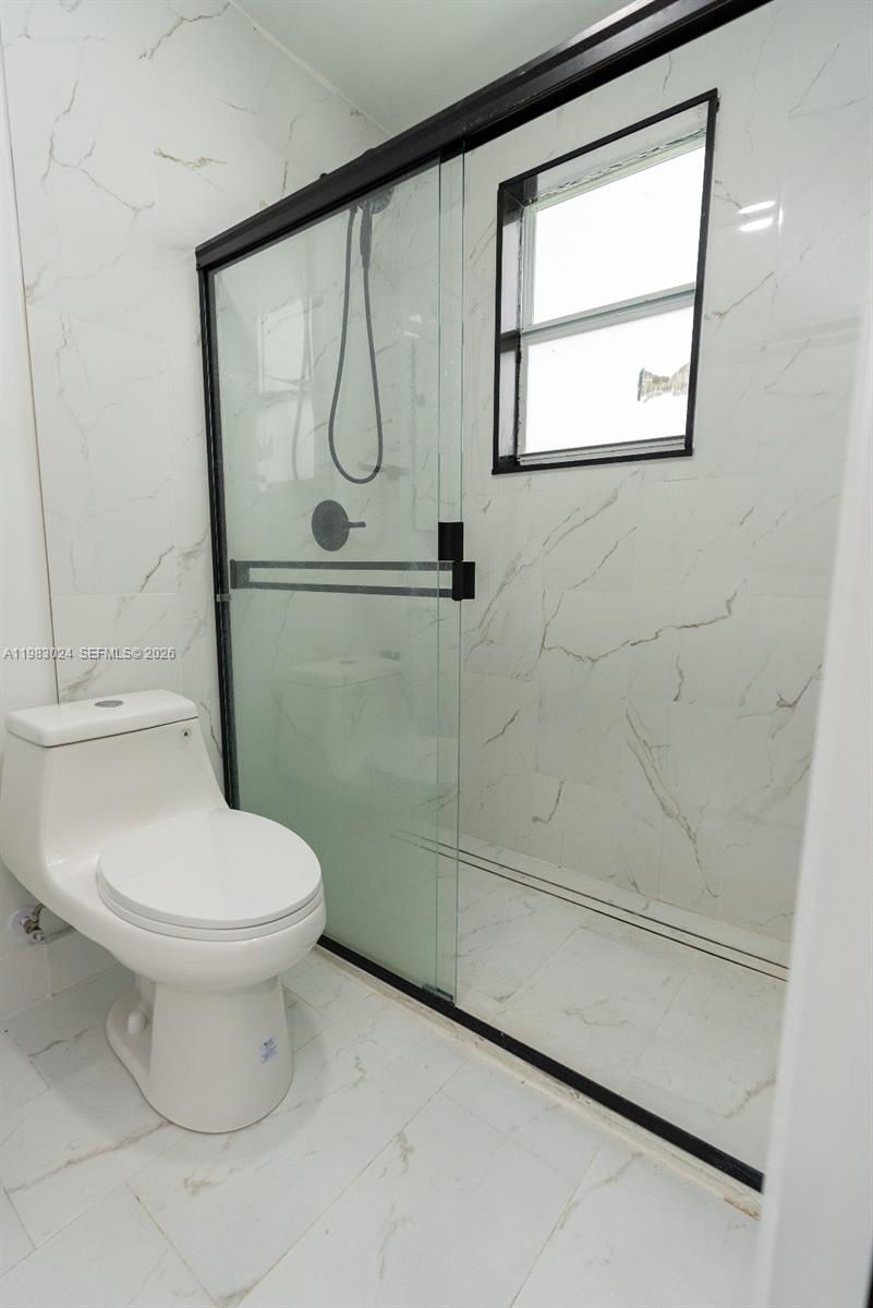 13270 Southwest 103rd Terrace, Unit 2 Miami, FL 33186 - Photo 30 of 41 a bathroom with a toilet and a shower