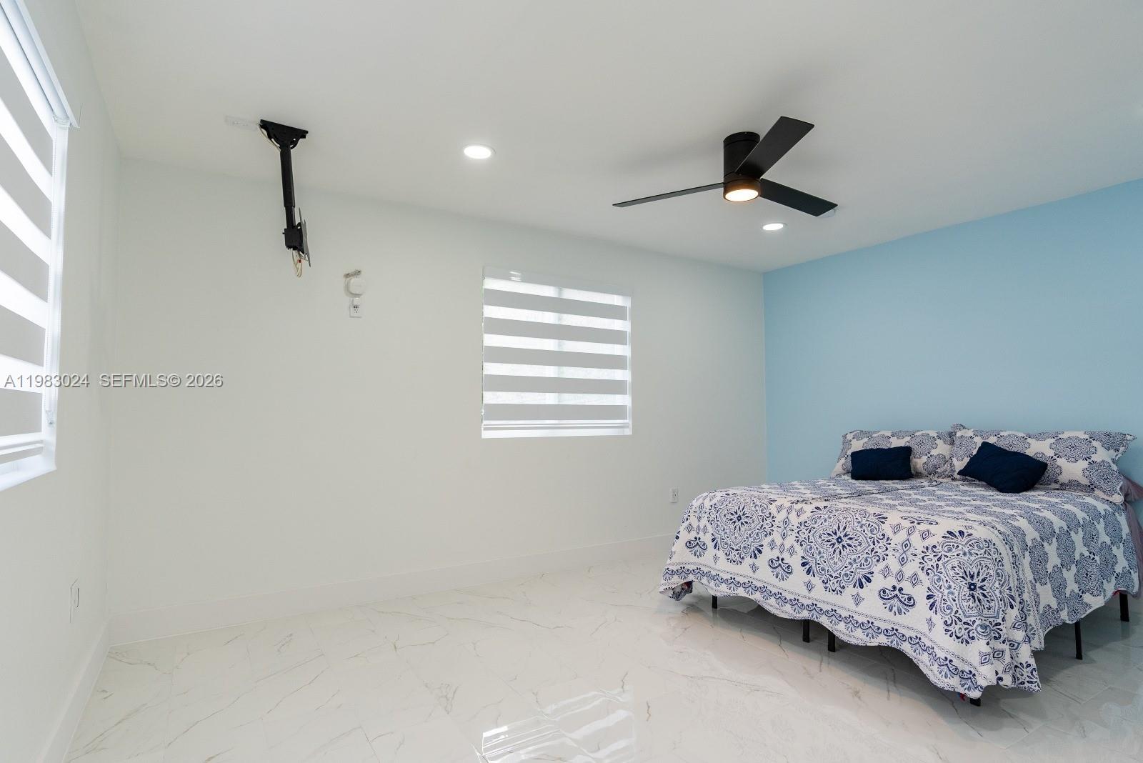 13270 Southwest 103rd Terrace, Unit 2 Miami, FL 33186 - Photo 34 of 41 a bedroom with a bed and a ceiling fan