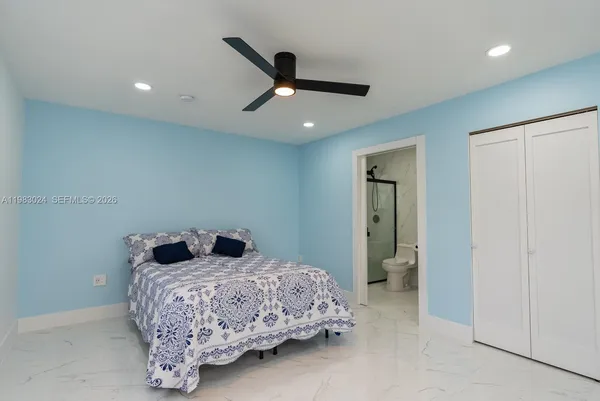 a bathroom with a toilet a sink and glass door