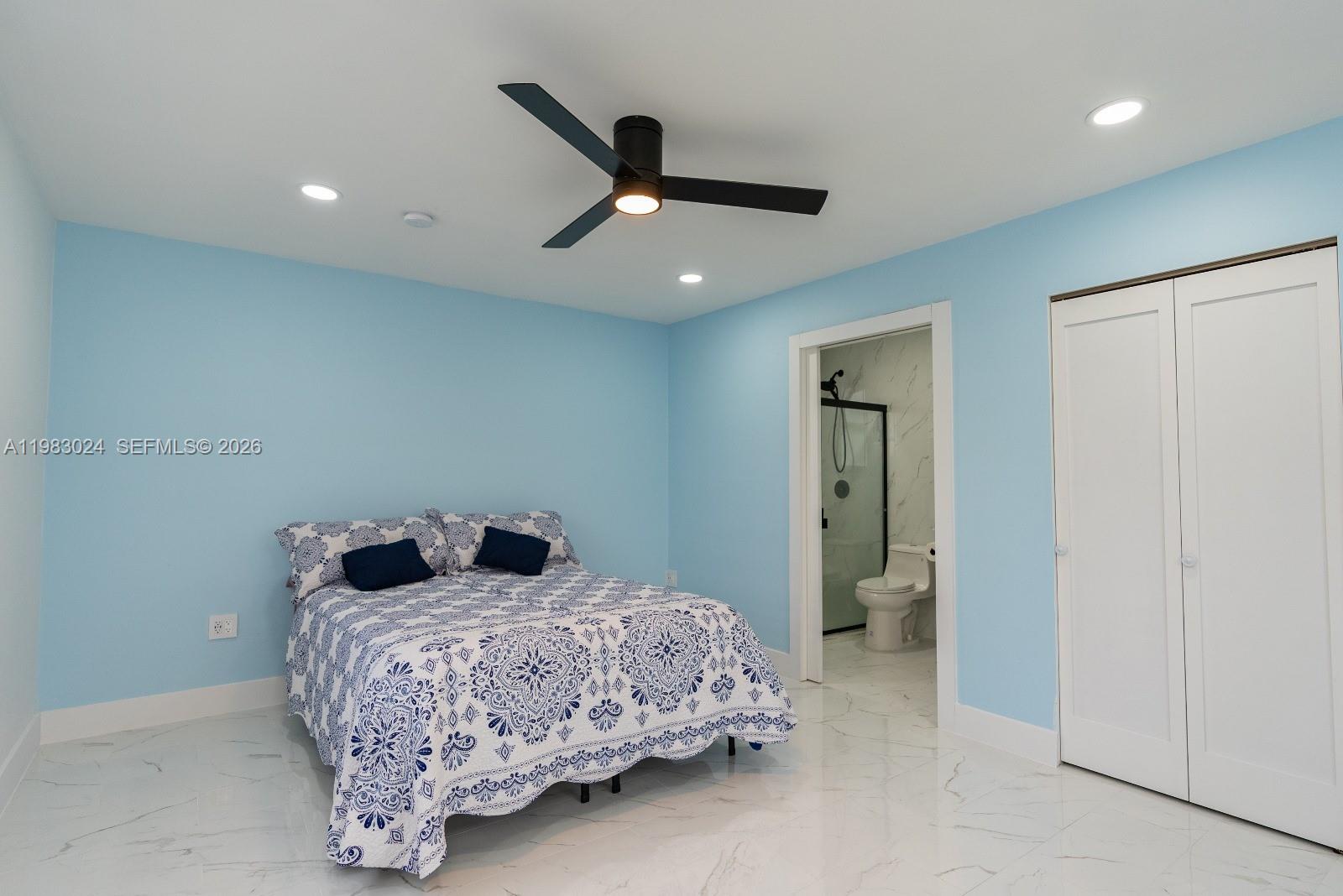 13270 Southwest 103rd Terrace, Unit 2 Miami, FL 33186 - Photo 35 of 41 a bedroom with a bed and a ceiling fan