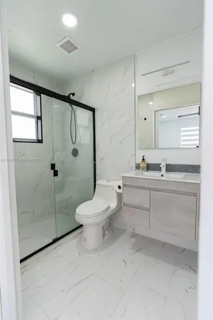 a bathroom with a toilet sink and shower