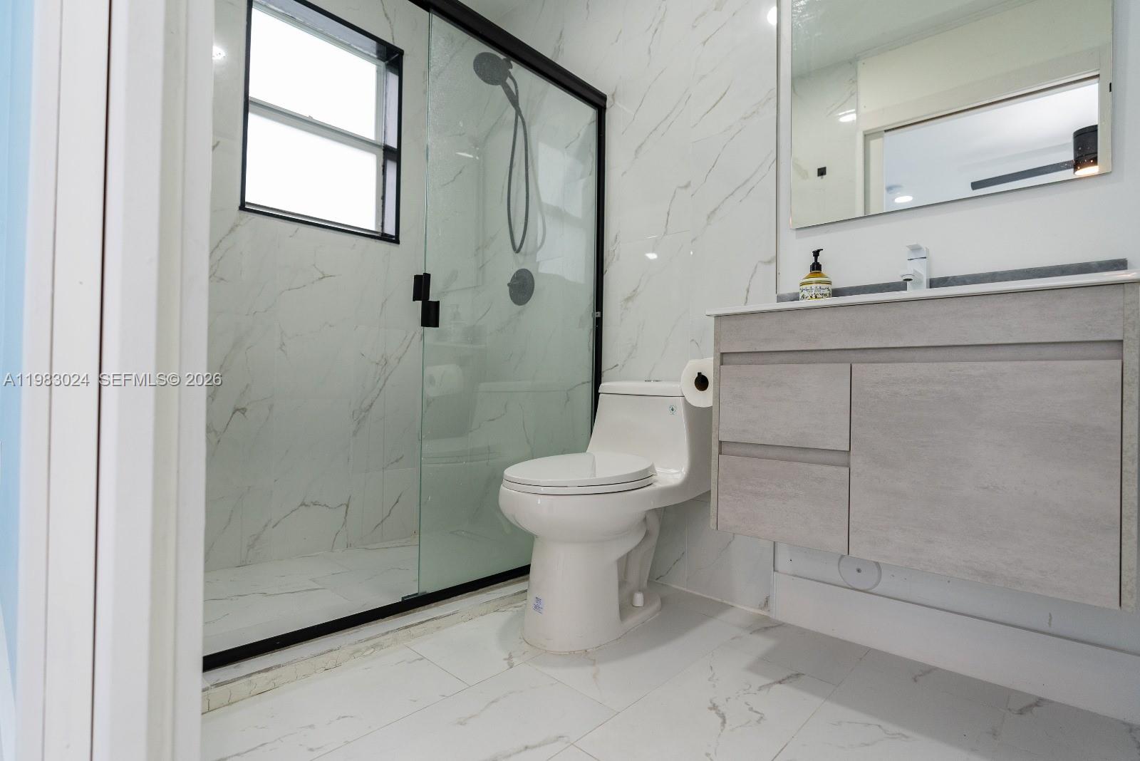 13270 Southwest 103rd Terrace, Unit 2 Miami, FL 33186 - Photo 37 of 41 a bathroom with a toilet sink and shower