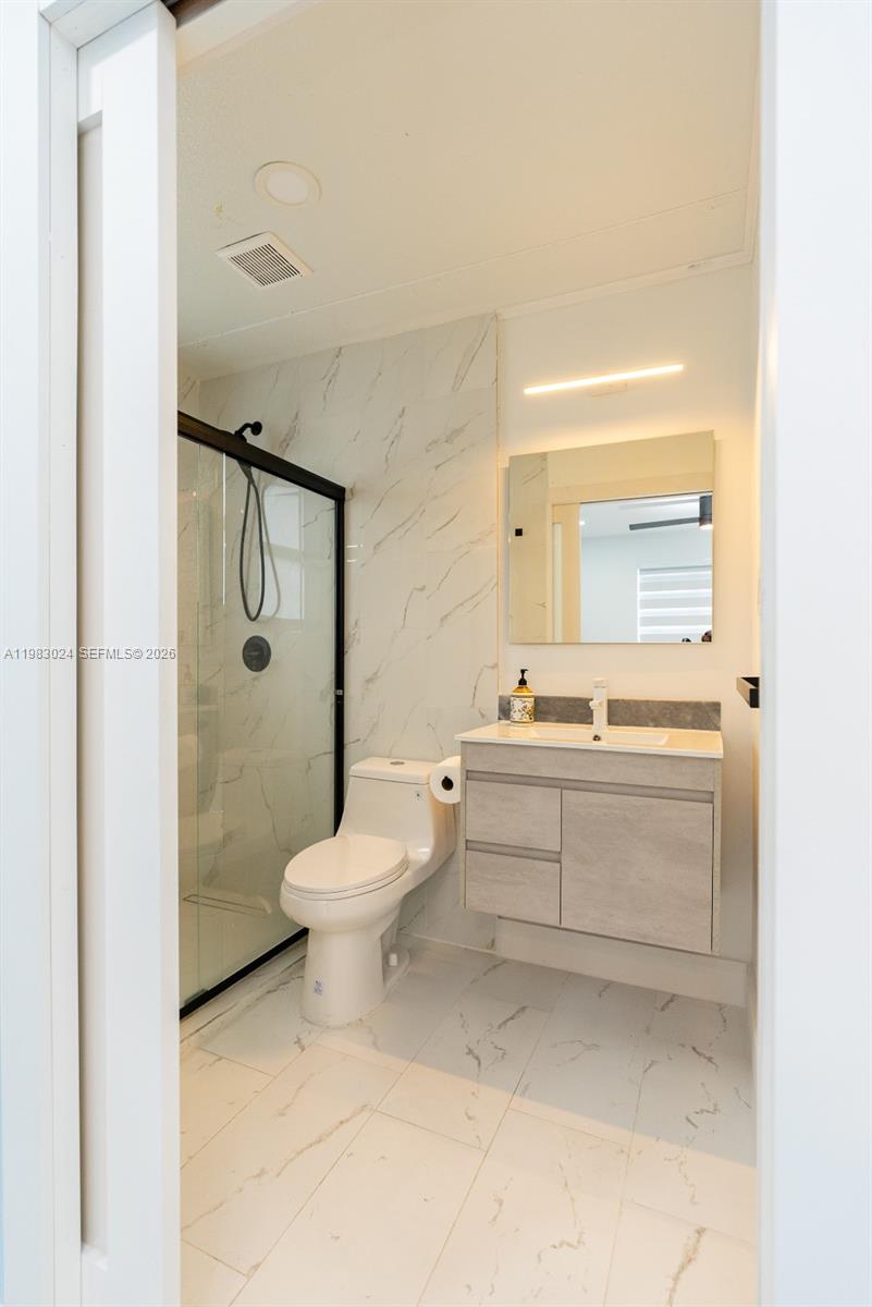 13270 Southwest 103rd Terrace, Unit 2 Miami, FL 33186 - Photo 38 of 41 a bathroom with a sink a toilet and shower