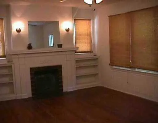 a view of a livingroom with an empty space and a fireplace