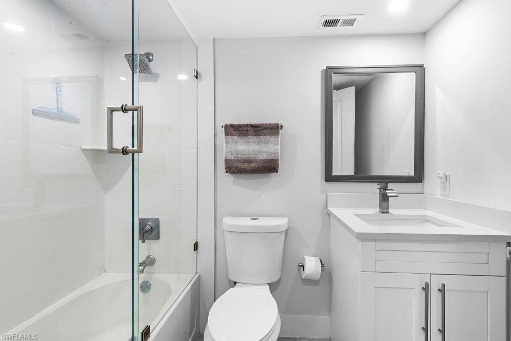 5 Bluebill Avenue, Unit 209 Naples, FL 34108 - Photo 13 of 32 a bathroom with a toilet sink and shower