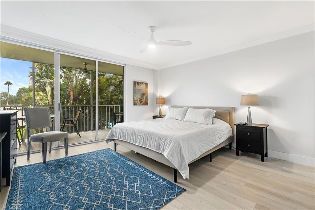 5 Bluebill Avenue, Unit 209 Naples, FL 34108 - Photo 16 of 32 a bedroom with a large bed and a large window