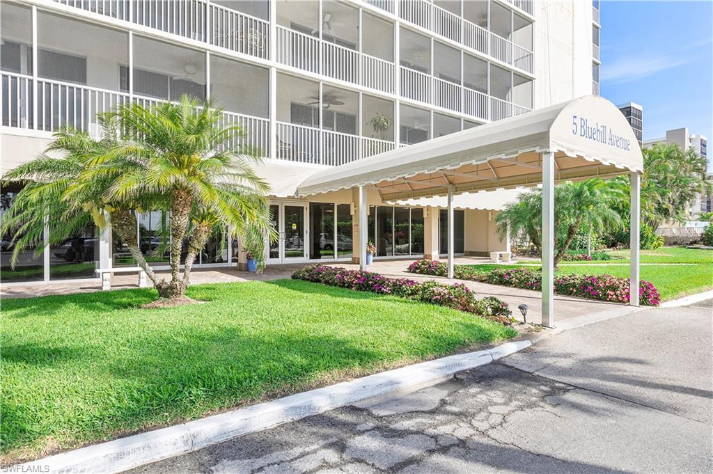 5 Bluebill Avenue, Unit 209 Naples, FL 34108 - Photo 18 of 32 a view of a house with a yard and sitting area