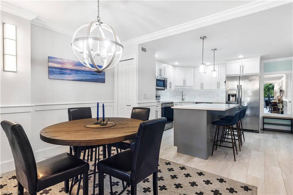 5 Bluebill Avenue, Unit 209 Naples, FL 34108 - Photo 2 of 32 a view of a dining room with furniture