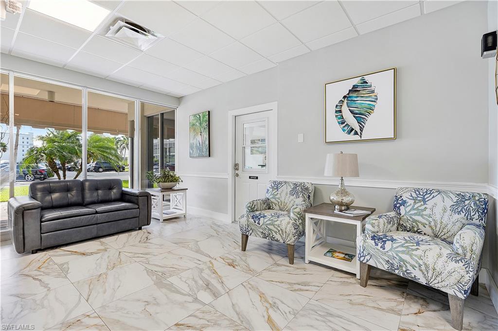 5 Bluebill Avenue, Unit 209 Naples, FL 34108 - Photo 23 of 32 a living room with furniture and a large window