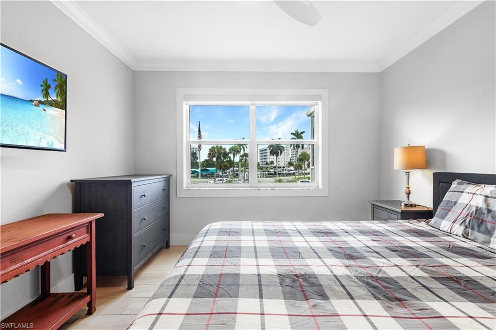 5 Bluebill Avenue, Unit 209 Naples, FL 34108 - Photo 3 of 32 a bedroom with a bed and a window