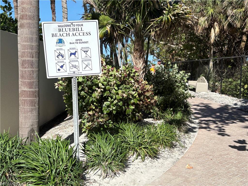 5 Bluebill Avenue, Unit 209 Naples, FL 34108 - Photo 31 of 32 a sign that is on a brick wall