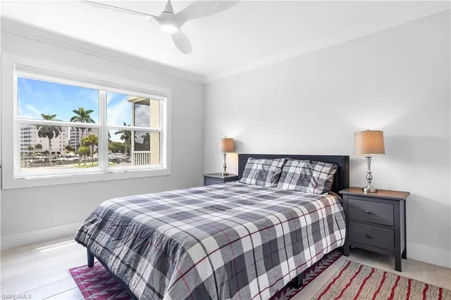 a bedroom with a bed and large window