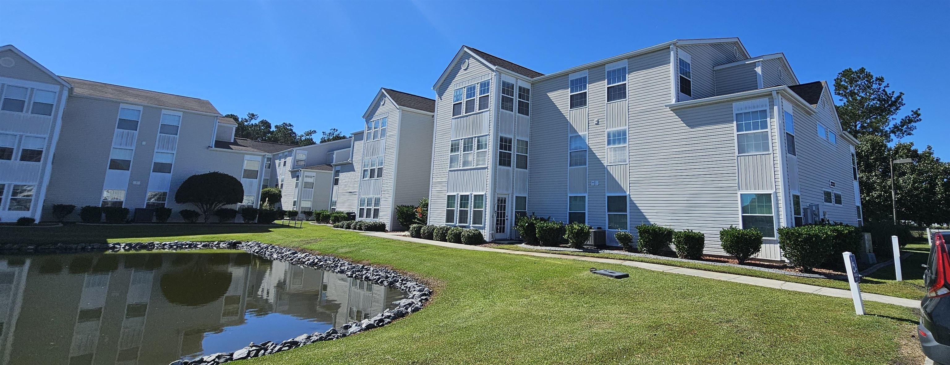 View of apartment building / complex with a water view